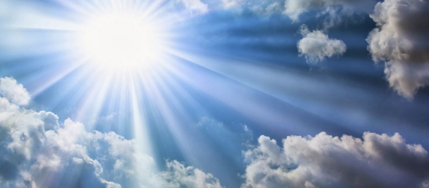 The bright sun blue sky clouds