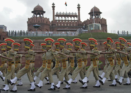 Indian soldiers march past the historic red fort during the full dress rehearsal for india's independence day celebrations in delhi