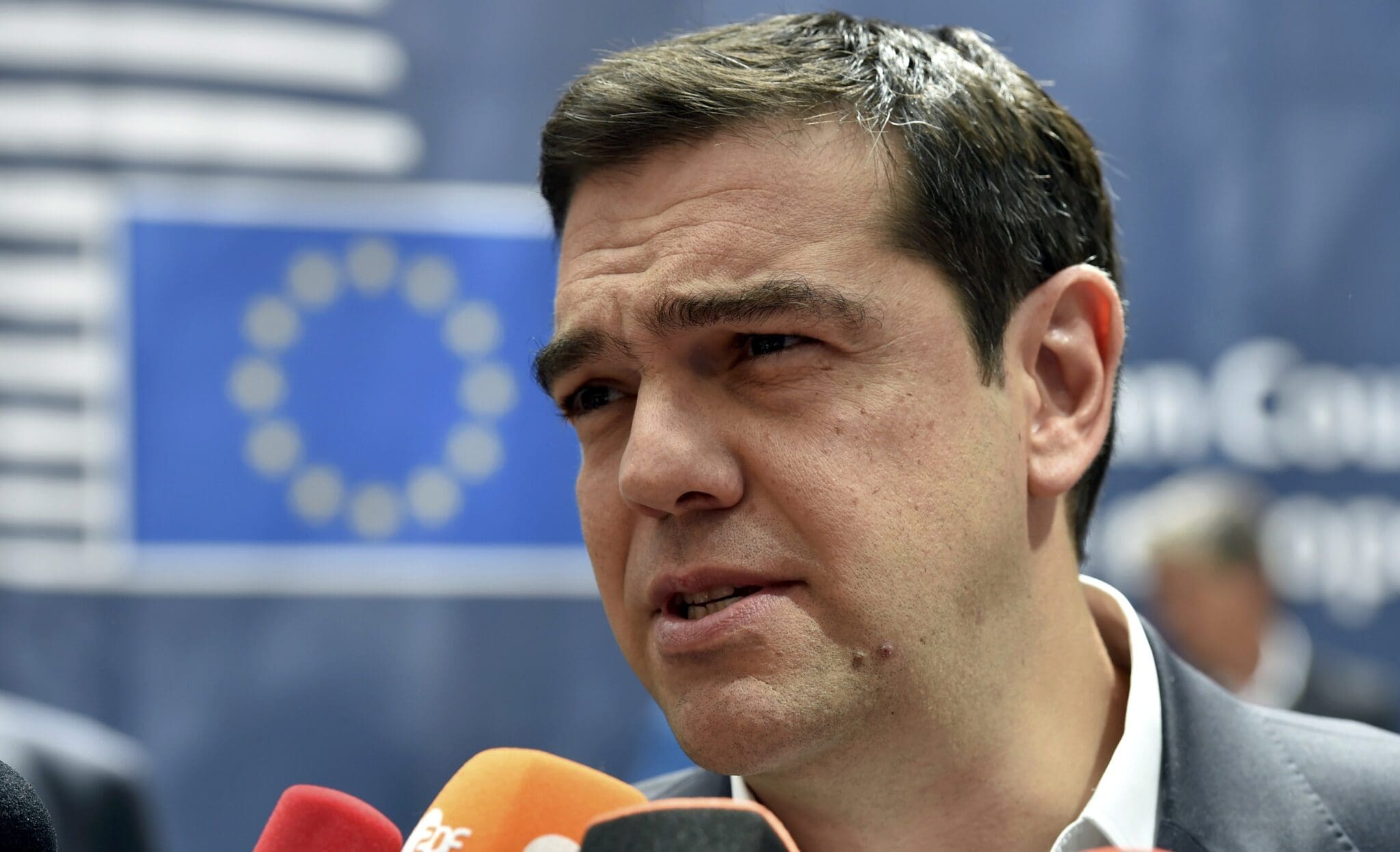 Greece's pm tsipras talks to the media as he arrives at the eu summit in brussels