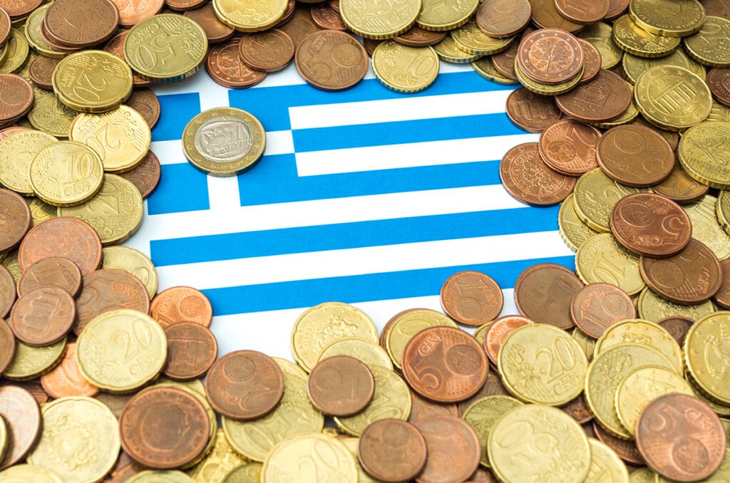 Euro,coins,placed,on,paper,sheet,with,printed,greece,flag