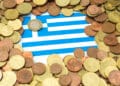 Euro,coins,placed,on,paper,sheet,with,printed,greece,flag
