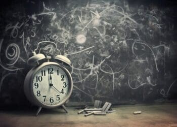 Alarm clock sitting front chalkboard wall 945053 1369 (1)