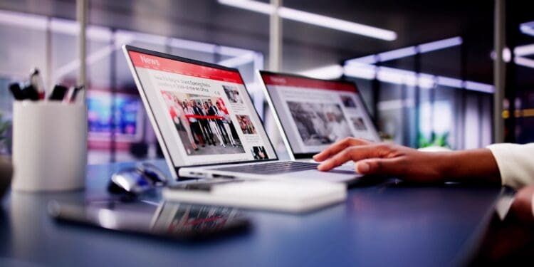 American,woman,views,online,news,articles,on,laptop,and,phone